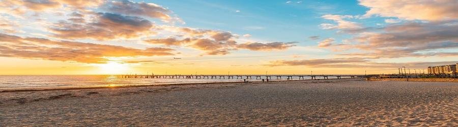 Sunset over Glenelg Beach in Adelaide with the jetty stretching into the ocean.
