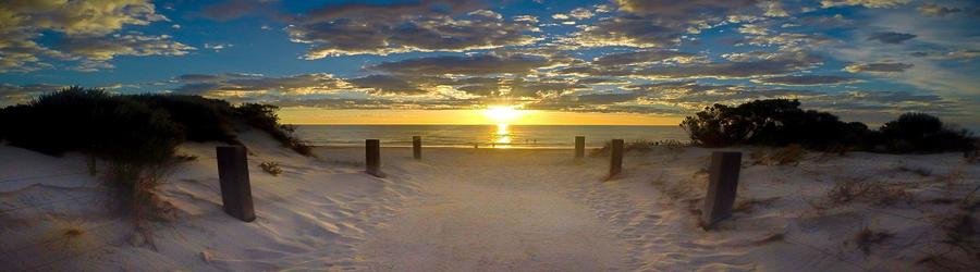 Sandy pathway leading to Henley Beach at sunset in Adelaide.