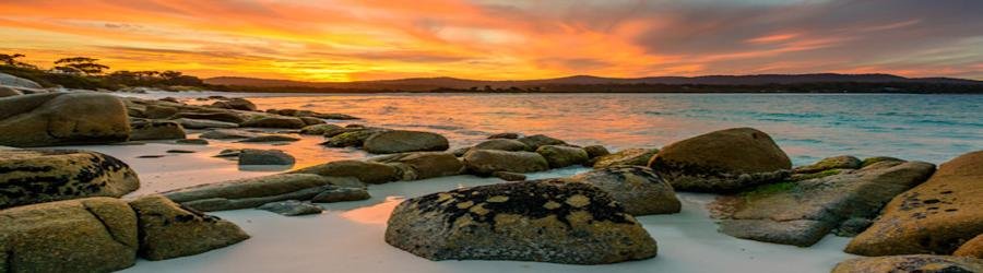 Bay of Fires, Tasmania, Beautiful Beaches in Australia, Bay of Fires Lodge, Sunset over the Bay of Fires in Tasmania with granite rocks, white sand, and colorful skies.