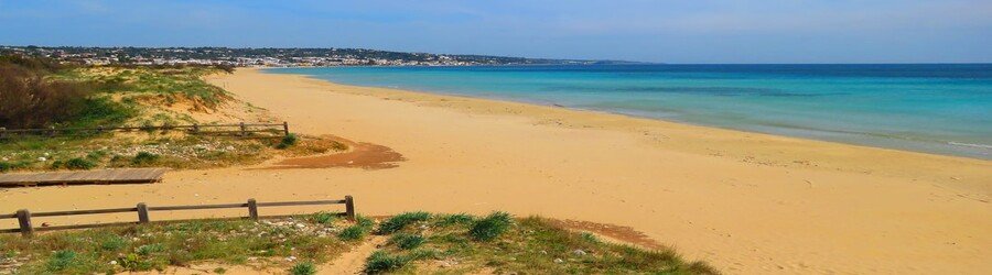 Marina di Pescoluse beach in Puglia with wide sand and shallow turquoise water