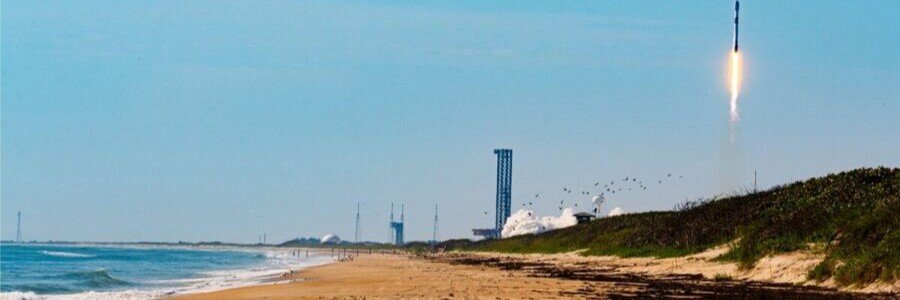 Rocket launch rising above the shoreline at Canaveral National Seashore on Florida's Space Coast.
