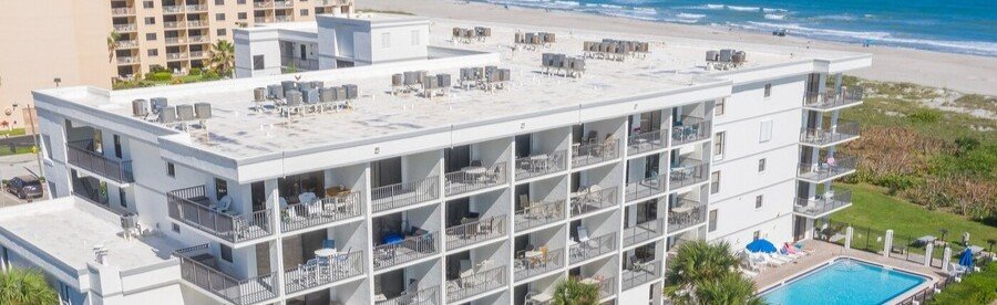 Cape Winds Oceanfront Condos overlooking the beach and swimming pool in Cocoa Beach, Florida.