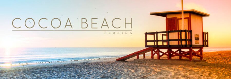 Panoramic view of a Cocoa Beach sunrise in Florida, featuring a classic wooden lifeguard tower on the sand next to calm ocean waves under a warm, glowing sky with text overlay.
