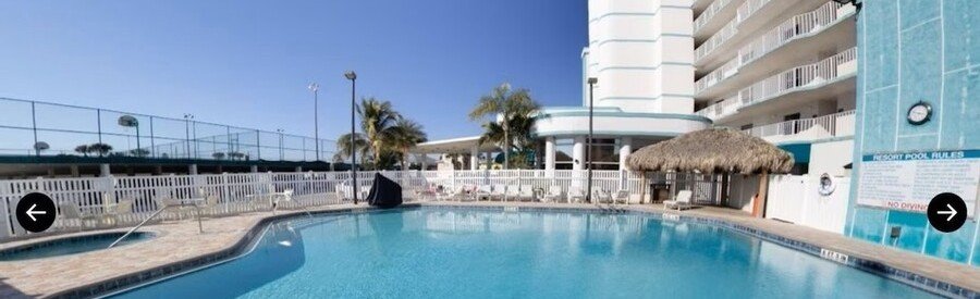 Swimming pool and resort amenities at Discovery Beach Resort in Cocoa Beach, Florida.