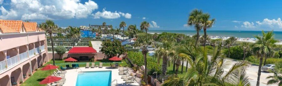 Oceanfront pool and tropical grounds at The Inn At Cocoa Beach overlooking the Atlantic Ocean.