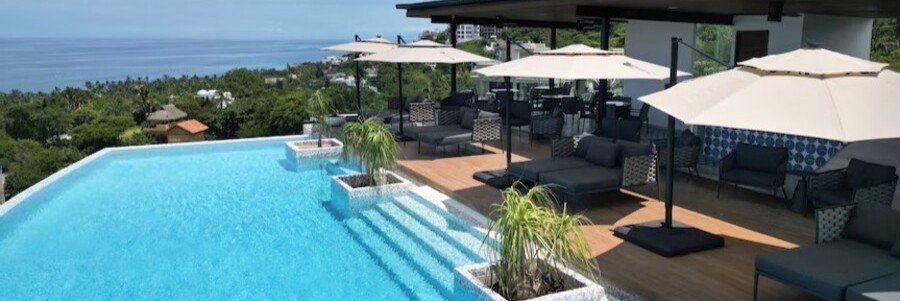 The rooftop infinity pool and sun deck at El Cielo Sayulita luxury apartments, overlooking the town and the Pacific Ocean.