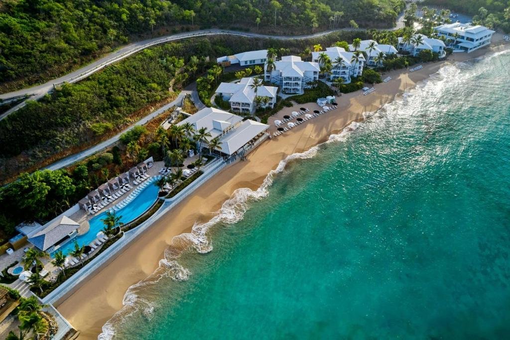 Aerial view of Buoy Haus Beach Resort in St thomas with beachfront pool, sandy shoreline, and turquoise water