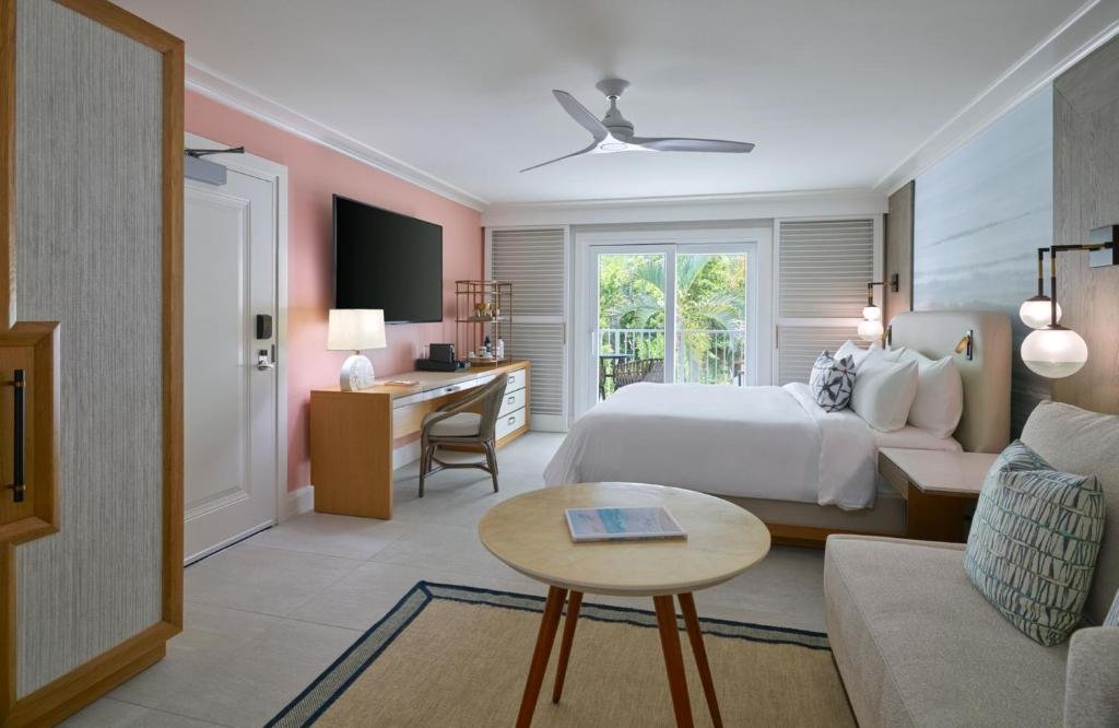 Bright modern guestroom at Buoy Haus Beach Resort in St thomas with balcony, neutral decor, and tropical accents