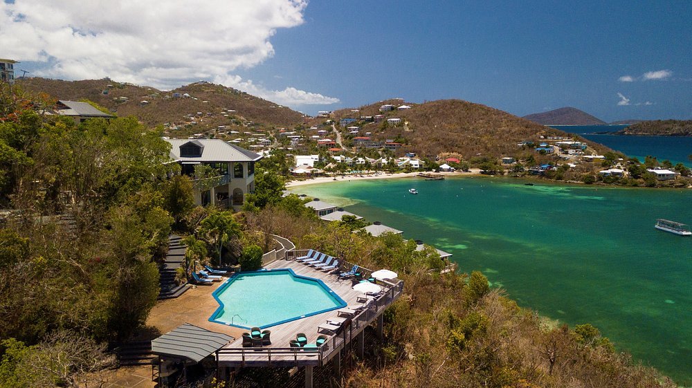 Aerial view of Point Pleasant Resort in St thomas with hillside pool and turquoise bay below