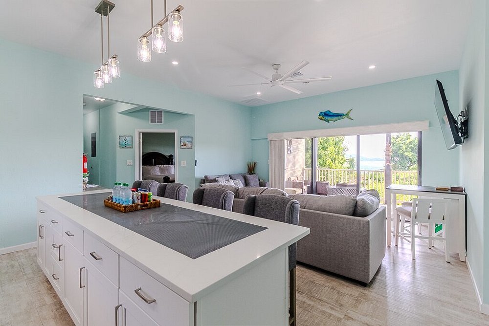 Open living and kitchen area at Point Pleasant Resort in St thomas with balcony access and ocean views