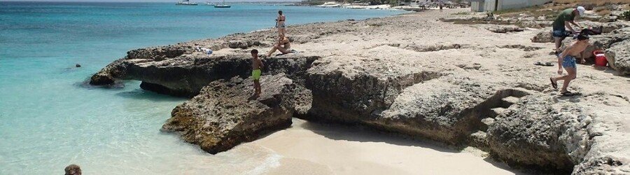Tres Trapi Steps Aruba rocky cove with carved stone steps leading into clear water