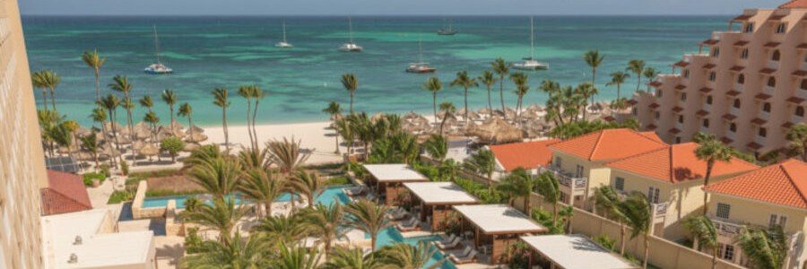 Hyatt Regency Aruba Resort Aerial Beach View | Beach Travel Destinations Aerial balcony view of the swimming pools and palm trees at Hyatt Regency Aruba Resort next to the Caribbean Sea