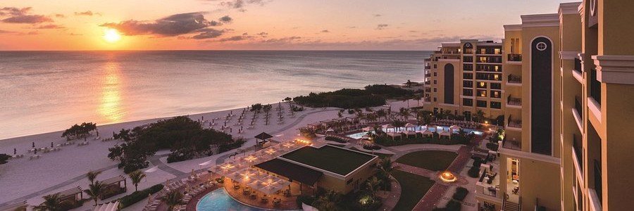 The Ritz-Carlton Aruba Sunset | Beach Travel Destinations High angle view of The Ritz-Carlton Aruba luxury resort next to Palm Beach at sunset