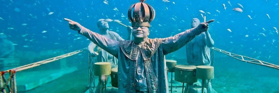 Underwater sculptures surrounded by tropical fish at the St. Martin Underwater Sculpture Park.