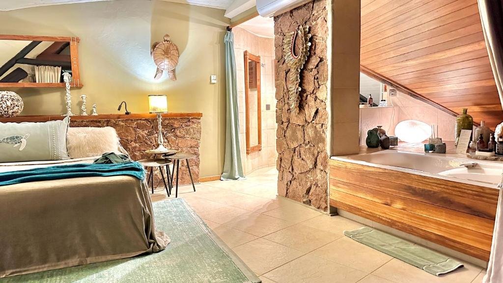 Private bungalow interior with bath and bedroom at Chateau de Feuilles Praslin