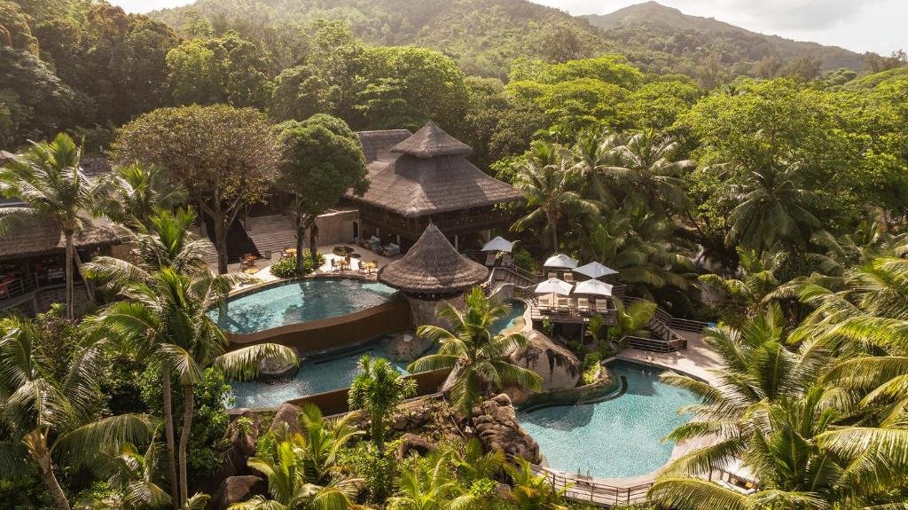 Constance Lemuria resort pool surrounded by tropical greenery on Praslin Island