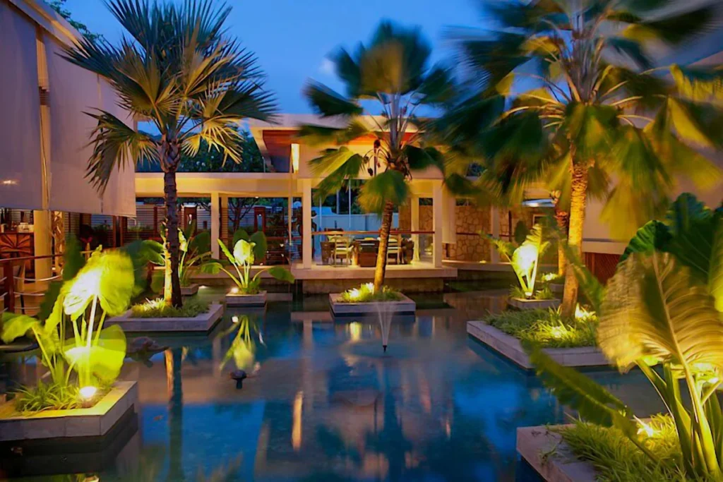 Illuminated pool courtyard at Dhevatara Beach Hotel Praslin Island
