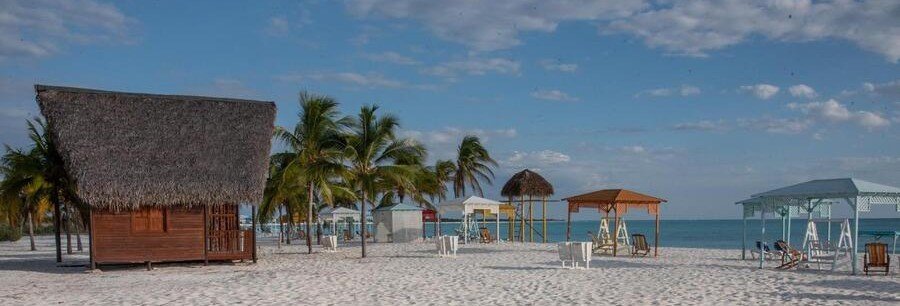 white sand and beach huts at Playa Sirena in Cayo Largo Cuba