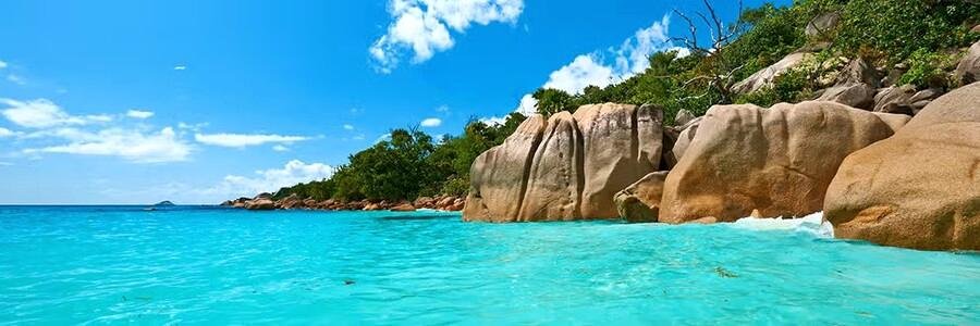 Turquoise water and granite boulders on Praslin Island beach in Seychelles