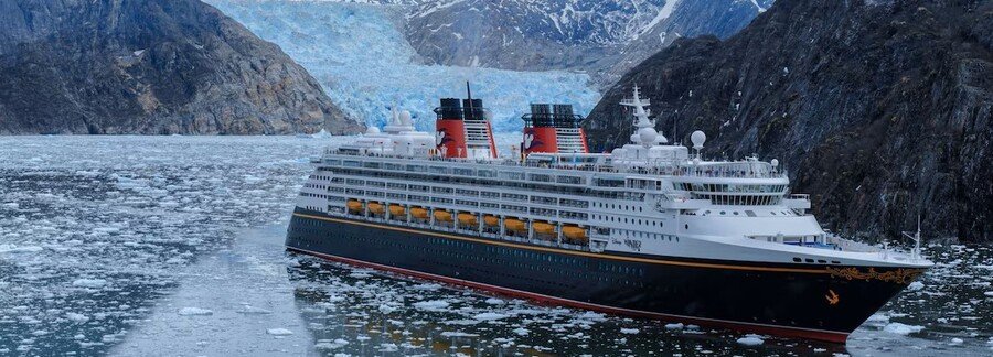 Alaska cruise ship sailing near glaciers with ice floes in scenic fjord landscape