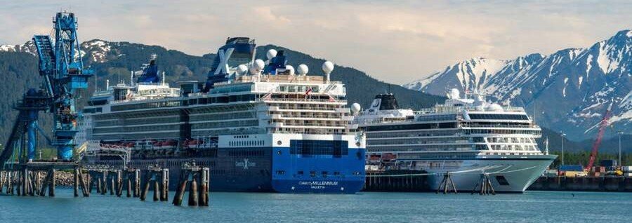 Cruise ships docked at Seward Alaska cruise port with mountains in background