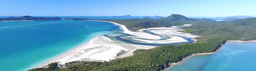 Aerial view of Whitehaven Beach with swirling white silica sand and bright turquoise water in the Whitsunday Islands.