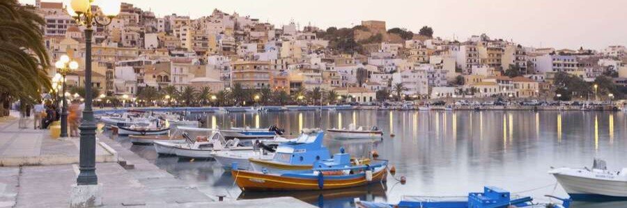 Agios Nikolaos Harbor near Crete Beaches with waterfront boats