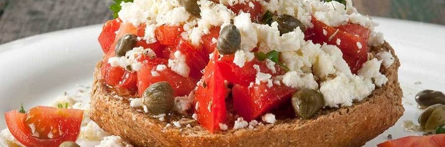 Traditional Dakos appetizer served near Crete Beaches