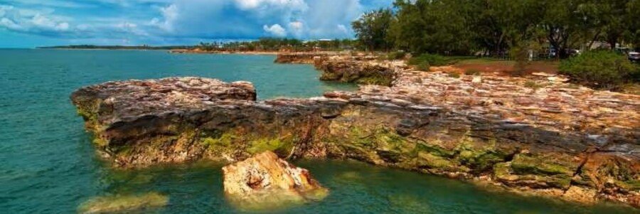 Rocky coastline overlooking the Timor Sea in Darwin, Australia, with turquoise water and tropical scenery.