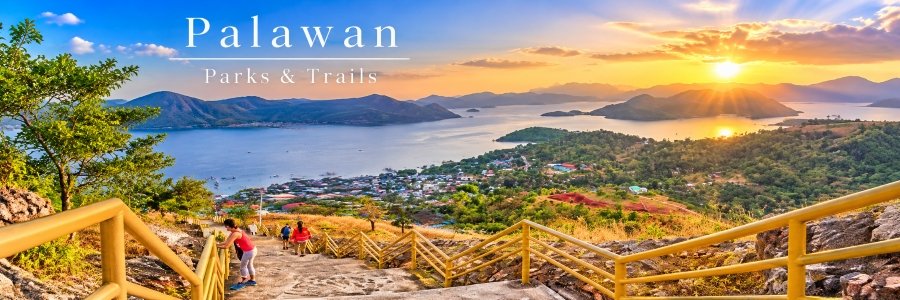 Mount Tapyas Trail in Coron, Palawan, featuring hillside stairs with yellow railings, lush green mountains, and panoramic island views at sunset.