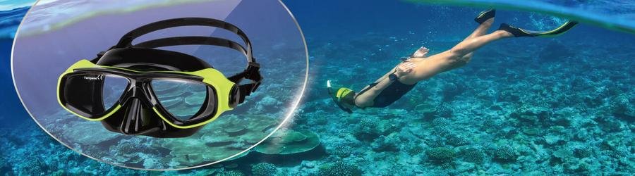 Snorkeling mask with diver exploring coral reef in the background.