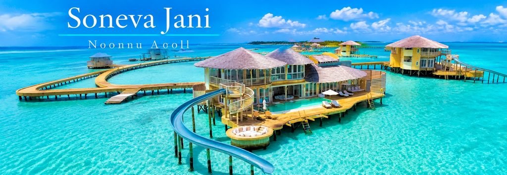 Aerial view of Soneva Jani in the Maldives, featuring luxurious overwater villas, private infinity pools, curved waterslides, and crystal-clear turquoise lagoons.