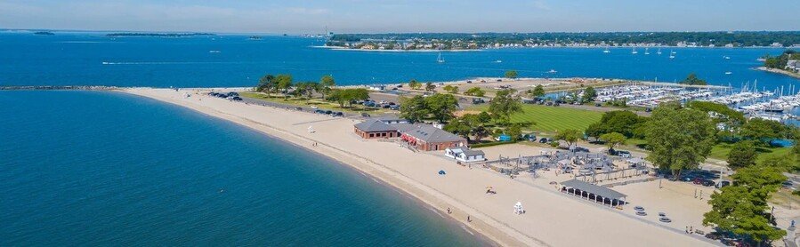 Compo Beach in Westport Connecticut aerial view with sandy shoreline marina and Long Island Sound coastline