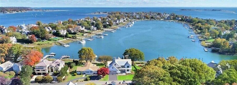 Aerial view of Westport Connecticut harbor with waterfront homes, boats, and coastal scenery along Long Island Sound