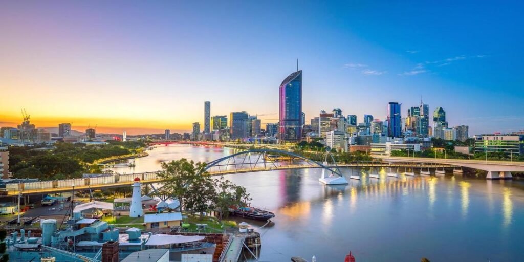 Brisbane city skyline at sunset with the river, bridges, and modern high-rise buildings., Visit Beautiful Brisbane