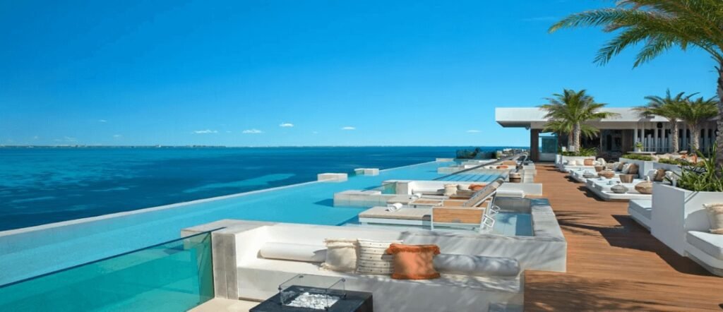 luxury oceanfront infinity pool at a Caribbean resort with modern lounge seating