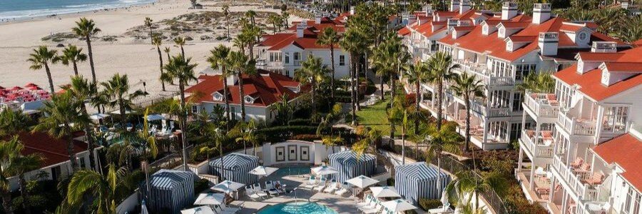 Exclusive red-roofed cottages and private pool with striped cabanas at Beach Village at The Del LXR Hotels and Resorts