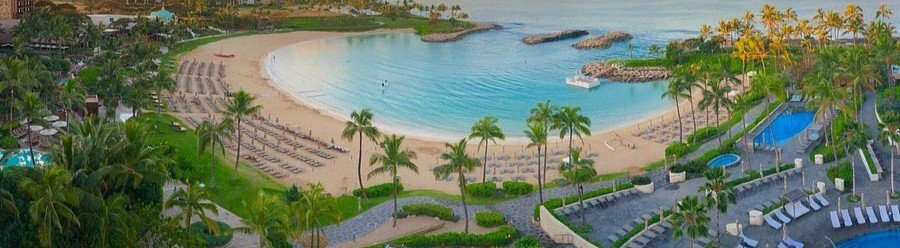 Aerial view of the crescent beach lagoon and beachfront grounds at Four Seasons Resort Oahu at Ko Olina