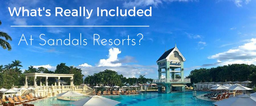 Sandals resort pool and beachfront lounge area with tropical buildings and blue sky in the Caribbean