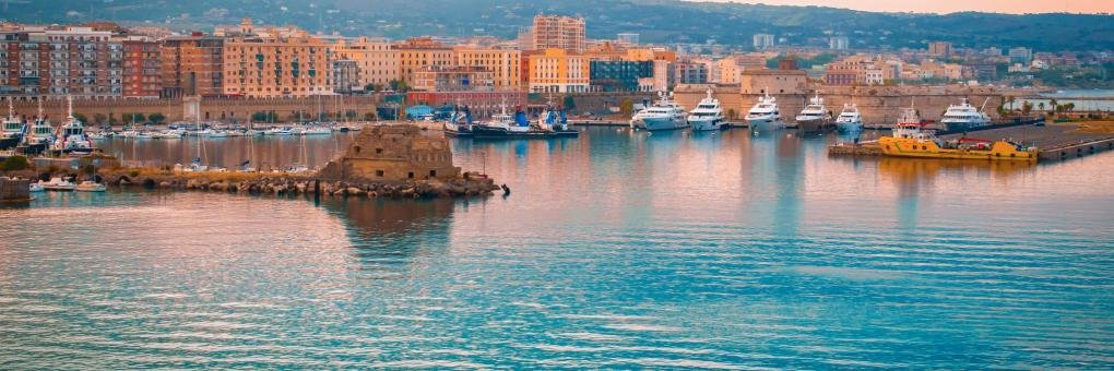 Civitavecchia cruise port harbor with marina, waterfront buildings, and boats near Rome Italy