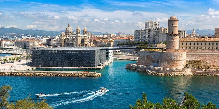 Marseille harbor view with MuCEM museum, Fort Saint-Jean, and Mediterranean waterfront skyline.