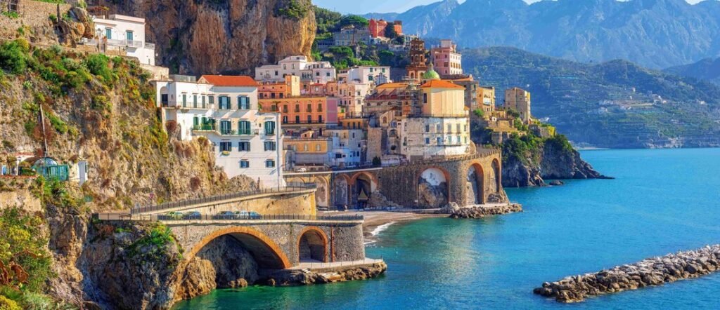 Colorful cliffside buildings in Sorrento overlooking the turquoise waters of the Bay of Naples along Italy’s Amalfi Coast