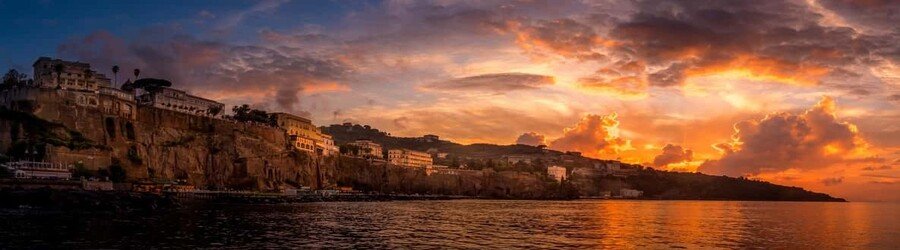 Sunset over the Sorrento coastline with cliffs and glowing sky