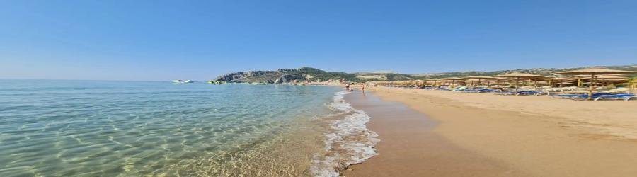 Faliraki Beach with sunbeds and clear water in the beautiful Rhodes Greece.