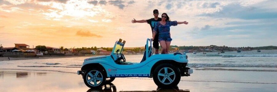 Couple posing on a beach buggy at sunset in Arraial do Cabo, Brazil