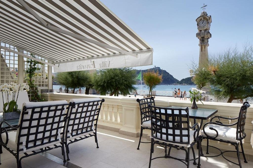 Outdoor terrace at Hotel Boutique Villa Favorita overlooking the beach and promenade