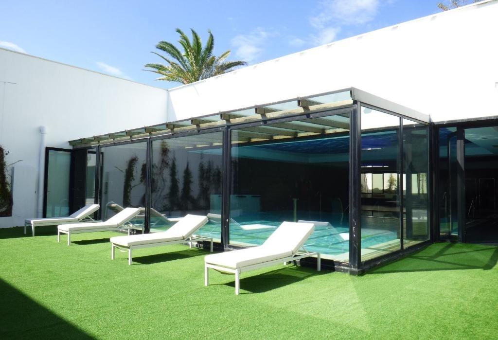 Indoor-outdoor pool area at Hotel & Thalasso Villa Antilla with lounge chairs