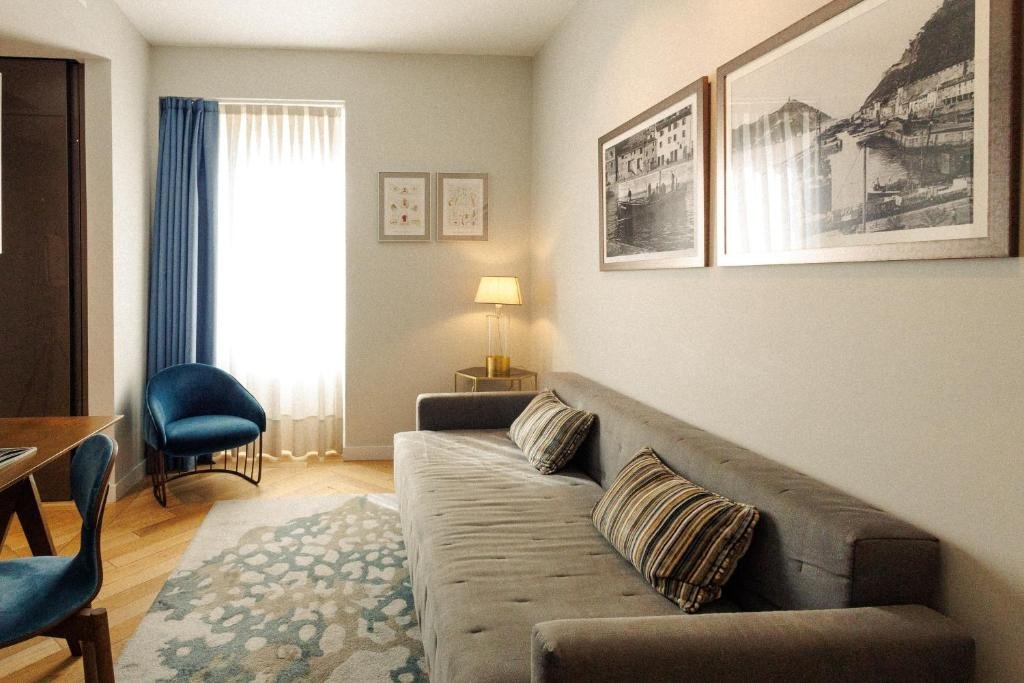 Modern living area at Lasala Plaza Hotel with sofa, chair, and soft natural light