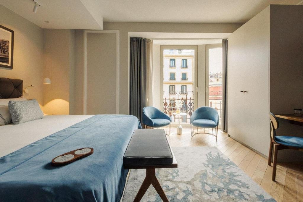 Elegant hotel suite at Lasala Plaza with balcony, seating area, and natural light