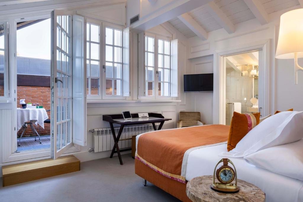 Elegant suite at Villa Magalean Hotel with terrace access and warm decor